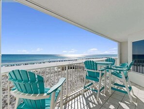 A balcony with turquoise chairs overlooking a beach. - 🦩Book Me Baby! Gulf-Front Condo Shore Thing 🦩 (Fort Walton Beach)