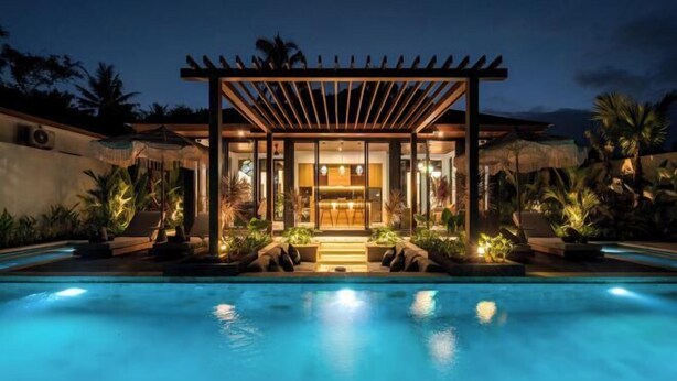 A modern poolside area with a covered seating area, a pool, and surrounding greenery. - Villa Aman by BaliSuperHost (Bali)