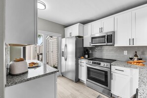 Fridge, microwave, oven, stovetop - Waterfront Escape with Gulf Access & Resort Amenities - Caper Point - Roelens (Fort Myers Beach)