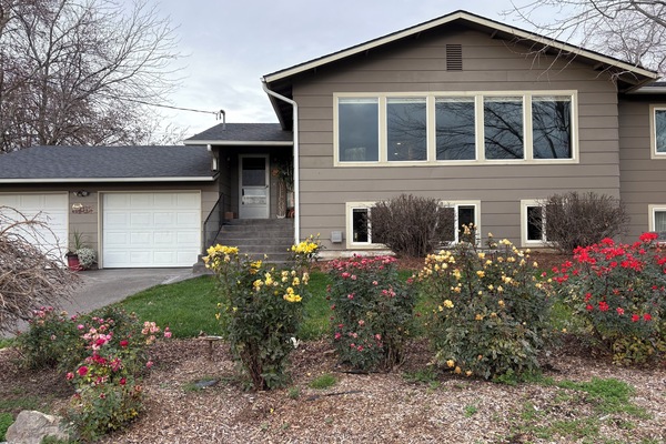 A warm welcome to our cozy, well-loved home surrounded by seasonal blooms.