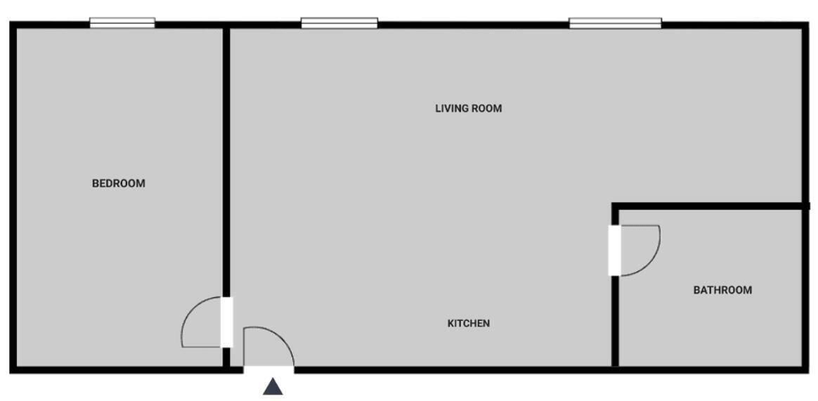 Een plattegrond met een slaapkamer, woonkamer, keuken en badkamer.