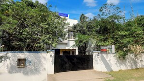 A gated entrance to a building with a sign indicating 'Ravana Kottai Rooms'. - Fabhotel Ravana Kottai (Chennai)