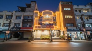A hotel with a prominent sign for 'Tab Hotels' and 'Heritage Laminates' in the center. - Via Ashirwad (Lucknow)