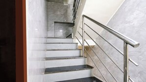 A staircase with metal railings and marble walls. - Fabhotel B Town (Mumbai)