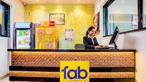 A hotel reception desk with a woven design, a vending machine, and a refrigerator. - Via RK Exclusive (Hinjawadi)
