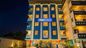 A multi-story building with a sign reading "fabHOTELS" at the entrance. - Via RK Exclusive (Hinjawadi)