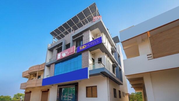 A multi-story building with a prominent solar panel on the roof, a sign for 'fabHOTELS', and a large glass entrance. - Fabhotel Ramraj Inn (Chhatrapati Sambhajinagar)