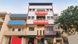 A multi-story building with a prominent red sign reading "THE DREAM INN" on the facade. - Fabhotel The Dream Inn (Faridabad)