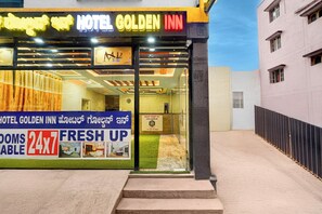 The exterior of Hotel Golden Inn with a signboard displaying room availability and a fresh-up service. - Via Golden Inn I (Bengaluru)