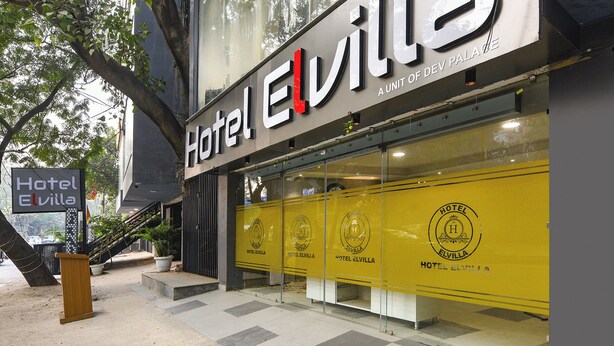A hotel named Hotel Elvilla with a modern facade, large windows, and a visible logo on the glass doors. - FabHotel Prime Elvilla I-@ Rajouri Garden, Delhi (New Delhi)