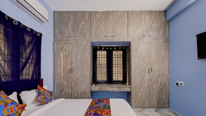 A bedroom with a bed, a window, and a wardrobe. - FabHotel Dream Inn - Mogappair East (Chennai)
