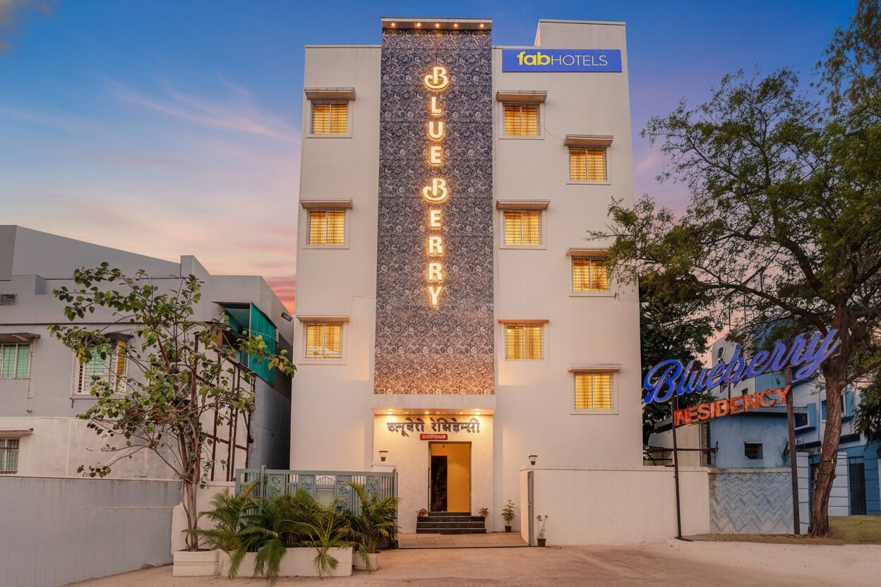 A hotel named 'Blueberry Residency' with a modern facade, multiple windows, and a prominent sign.