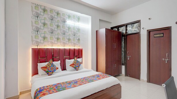 A hotel room with a large bed, a wardrobe, and a door labeled "WASHROOM". - Fabhotel Tree View Residency (Lucknow)