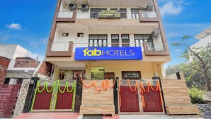 A multi-story building with a sign for 'fabHOTELS' indicating it is a hotel. - Fabhotel Tree View Residency (Lucknow)