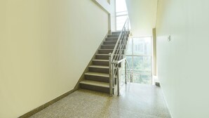 A staircase with metal railings leading to a landing. - Via Reyansh (Jaipur)