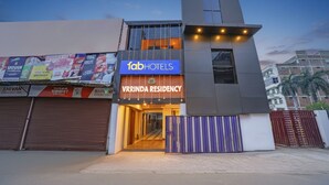 A modern building with a sign for 'fab hotels' and 'VRRINDA RESIDENCY'. - Fabhotel Vrrinda Residency (Varanasi)