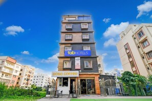 A multi-story building with a sign for 'fab hotels' and a 'dosa coffee' shop at the ground level. - FabHotel Bhumi Inn (Barasat)