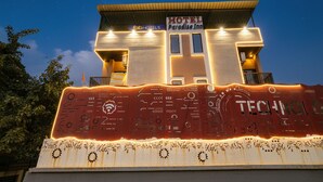 A hotel named Paradise Inn with a modern design, featuring a flat roof and illuminated signage. - Fabhotel Paradise Inn (Indore)
