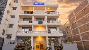 A multi-story hotel with a modern facade, balconies, and a sign reading "fabHOTELS". - Fabhotel Sager Inn (Gurugram)