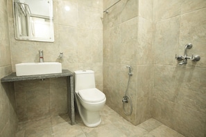 A bathroom with a sink, toilet, and shower. - Fabhotel The Glory (Rishikesh)
