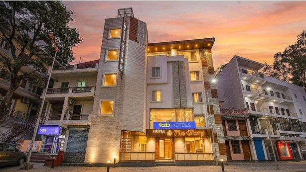 A multi-story hotel with a prominent 'fab hotels' sign, a visible entrance, and a staircase leading to the upper floors. - Fabhotel The Glory (Rishikesh)