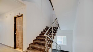 A staircase with metal railings leading to a landing.