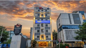 A multi-story hotel with a prominent sign for 'Wild Wings Hotel' and 'FabHotels' branding.