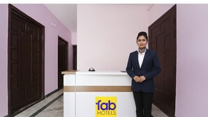 A hotel reception desk with a sign reading "Tab Hotels". - Via Yellow Mist Home Stay (Kodaikanal)