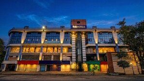 A multi-story hotel with a modern facade, multiple balconies, and a prominent 'fabHOTELS' sign. - Fabhotel Anjani (Ahmedabad)