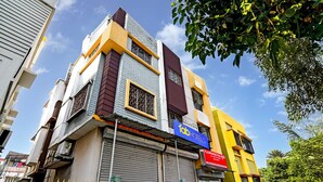 A multi-story building with a prominent 'fab hotels' sign, a 'Florence Palace' sign, and a gated entrance. - Fabhotel Florence Palace (Kolkata)