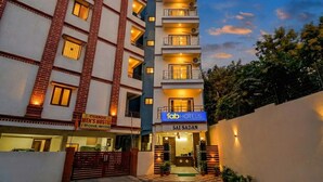 A multi-story hotel with a prominent sign for 'fab hotels' and a hostel named 'Chandu Men's Hostel'. - Fabhotel Heaven 75 (Hyderabad)