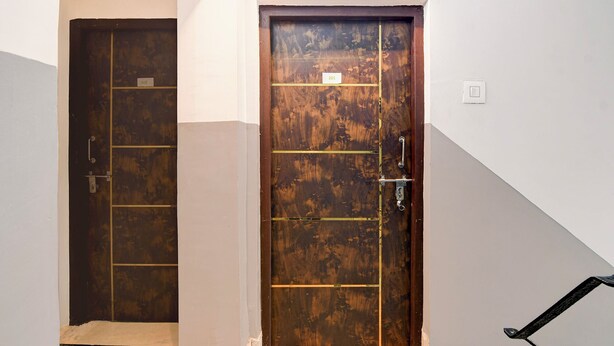 A room with two wooden doors, one with a number 201 and another with a number 202. - Via Rajdanga Retreat (Kolkata)