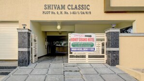 The entrance to Shivam Classic, a hotel with a sign indicating guest rooms and co-living spaces. - FabHotel Honey Grand - 400m From Yashoda Hospitals, Hitech City. (Hyderabad)