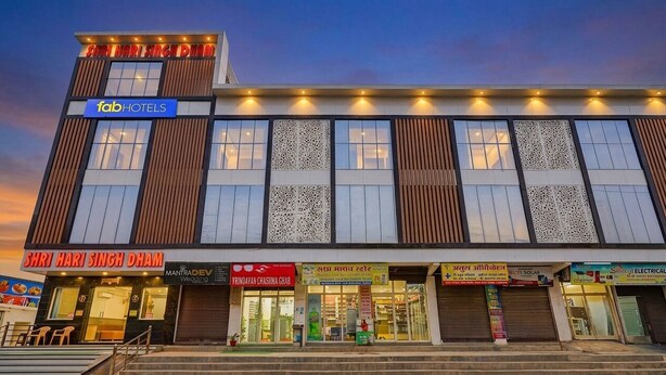 A multi-story building with a sign for 'fabHOTELS' at the top. - Fabhotel Shri Hari Singh Dham (Vrindavan)