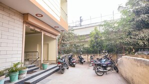 A building with a brick facade and a covered entrance. - Via BD Palace (New Delhi)