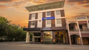 A hotel named 'Hotel Blumark' with a modern facade, a sign for 'FabHotels', and a 'Sones' store on the right. - Fabhotel Blu Mark (Indore)