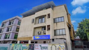 A multi-story building with a sign for 'fabHOTELS' on the ground floor. - Via Blissful Stays (Navi Mumbai)