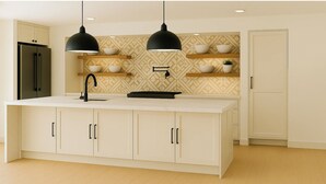 A modern kitchen with a central island, black pendant lights, and a patterned backsplash. - Spacious 6-bedroom estate with AC in Atlanta (Atlanta)
