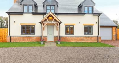 Stylish modern home with games room, luxury kitchen and two en suite bedrooms.