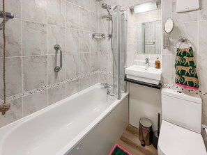 A bathroom with a bathtub, a shower, a sink, and a toilet. - A lovely lodge in a great holiday village. (Kingsdown, Deal)