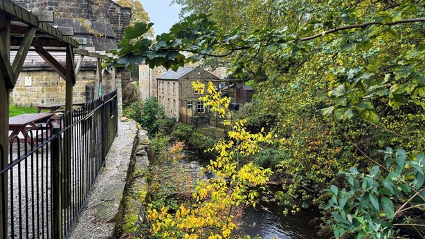 A stone bridge, a wooden pavilion, and a river with surrounding greenery. - Mini Goose cottage - UKC7088 (Laycock)