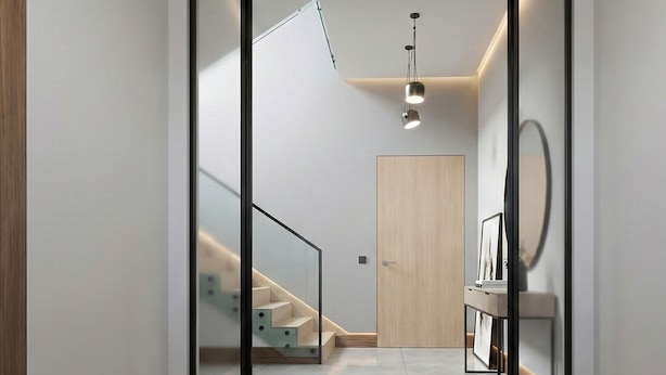 A modern hallway with a glass door leading to a staircase, a wooden door, and a small table with a mirror. - Exceptional place ready to welcome you (Montreuil)