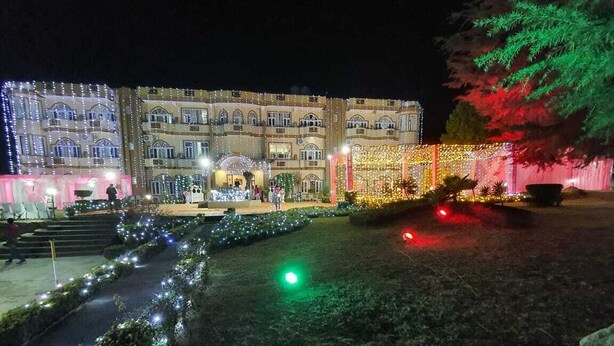 A building with multiple balconies and a well-lit entrance. - ImperialHeightsResortReimaginedbyNirvana (Dharamshala)