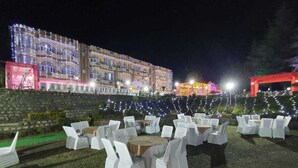 An outdoor event space with tables and chairs arranged for an event. - ImperialHeightsResortReimaginedbyNirvana (Dharamshala)