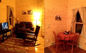 A wooden cabin interior with a living area, a dining table, and a fireplace.
