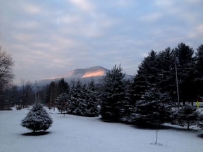 A snowy landscape with a mountain in the background.
