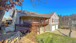 A two-story house with a balcony, a garage, and a basketball hoop. - Covered Deck & Fire Pit: Weaverville Getaway! (Weaverville)