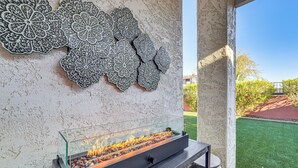 A glass-top fire feature with a metal decorative panel above it. - < 1 Mi to Golf: Charming Ahwatukee Foothills Villa (Phoenix)
