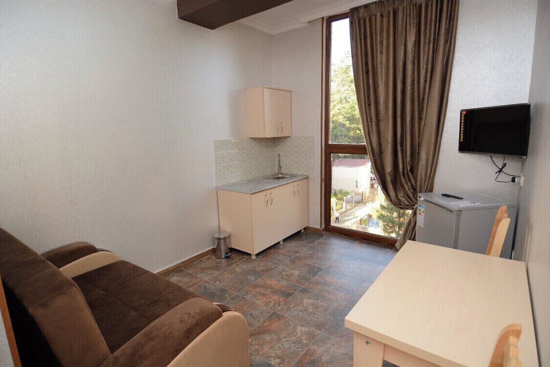 Deluxe Quadruple Room | In-room safe, iron/ironing board, free WiFi, bed sheets