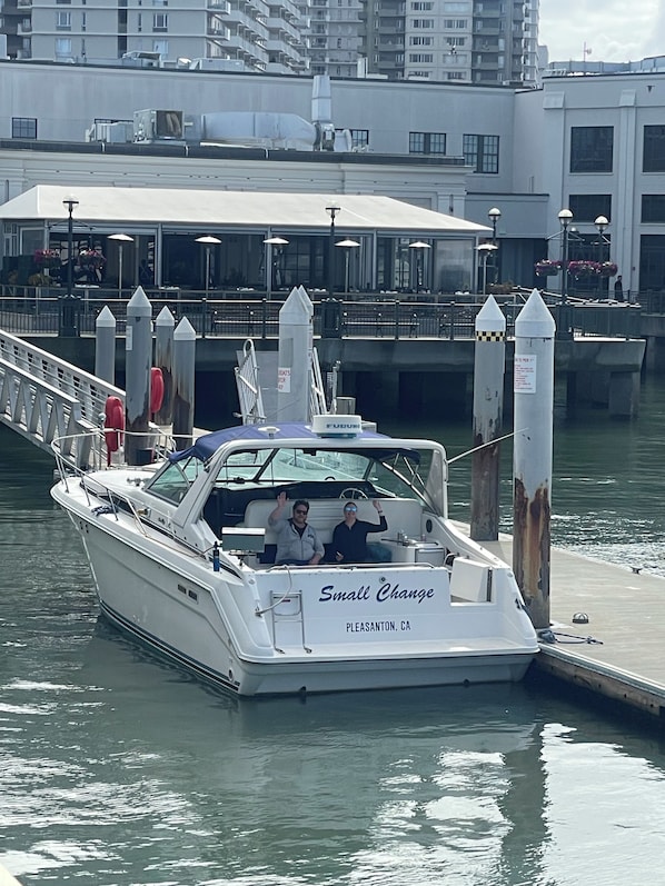 A boat docked at a pier with 'Small Change' written on the side, indicating a possible restaurant or business.